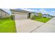 Charming single-Gathering home with lush landscaping, a well-maintained lawn, and a spacious driveway at 415 Overpool Ave, Davenport, FL 33896