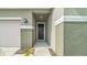 The front exterior features an elegant door and two-car garage at 415 Overpool Ave, Davenport, FL 33896