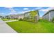 The exterior of a charming home featuring a beautifully landscaped front yard at 415 Overpool Ave, Davenport, FL 33896