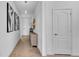 Bright hallway with neutral tile flooring, pendant lights, and modern decor creates a welcoming entrance at 415 Overpool Ave, Davenport, FL 33896
