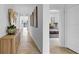 Hallway featuring neutral tile flooring, pendant lights, leading to an open living space and bedroom at 415 Overpool Ave, Davenport, FL 33896