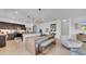 Open-concept kitchen featuring stainless steel appliances, dark cabinetry, a center island, and an adjacent living space at 415 Overpool Ave, Davenport, FL 33896