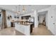Well-lit kitchen with granite countertops, stainless steel appliances, a center island, and tile floors at 415 Overpool Ave, Davenport, FL 33896