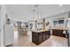 Open kitchen and living area featuring granite countertops, tile flooring, stainless steel appliances, and lots of natural light at 415 Overpool Ave, Davenport, FL 33896