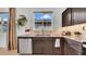 Kitchen with granite countertops, stainless steel appliances, ample cabinet space, and natural light from the window at 415 Overpool Ave, Davenport, FL 33896