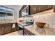 The kitchen features granite countertops and stainless steel appliances at 415 Overpool Ave, Davenport, FL 33896