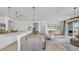 Open concept living space with a large dining table, an entertainment center, and a modern chandelier at 415 Overpool Ave, Davenport, FL 33896