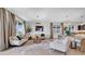Open-concept living room featuring neutral furniture, a decorative rug, and large windows offering ample natural light at 415 Overpool Ave, Davenport, FL 33896