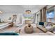 Spacious living room with stylish furnishings, a modern chandelier, and sliding glass doors at 415 Overpool Ave, Davenport, FL 33896