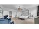 Luxurious main bedroom with a four-poster bed, plush seating, and elegant lighting at 415 Overpool Ave, Davenport, FL 33896