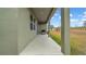Relaxing covered patio space with an outdoor grill, perfect for entertaining and enjoying the backyard at 415 Overpool Ave, Davenport, FL 33896