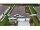Aerial view showcases this property's roof, three-car garage, and well-maintained landscaping at 449 Halter Dr, Apopka, FL 32712