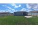 Spacious backyard showcasing a well-maintained lawn, screened porch and an expansive patio area at 449 Halter Dr, Apopka, FL 32712