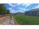 The backyard features a lush lawn, privacy fence, and well-defined garden beds, creating a serene outdoor space at 449 Halter Dr, Apopka, FL 32712