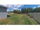 Well-maintained backyard features lush grass, a privacy fence, and defined garden beds for an inviting outdoor space at 449 Halter Dr, Apopka, FL 32712