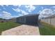 Wide backyard featuring a screened patio and well-manicured lawn, ideal for Gathering enjoyment at 449 Halter Dr, Apopka, FL 32712