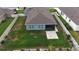A spacious fenced backyard, perfect for outdoor activities, featuring a patio area extending from a screened-in porch at 449 Halter Dr, Apopka, FL 32712