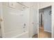 The bathroom includes a bathtub with white tiled walls and an overhead shower, complemented by a wall storage niche at 449 Halter Dr, Apopka, FL 32712