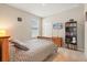 Cozy bedroom with neutral walls, carpeted floor, wooden bed frame, window, and a black bookshelf at 449 Halter Dr, Apopka, FL 32712