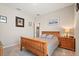 Relaxing bedroom features a wooden bed frame, neutral walls, carpeted floor, framed art, and matching nightstand at 449 Halter Dr, Apopka, FL 32712