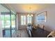 Bright dining room features a modern chandelier, plantation shutters, and sliding glass door to the patio at 449 Halter Dr, Apopka, FL 32712