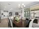 Open-concept dining room with access to the kitchen, living room, and outdoor patio at 449 Halter Dr, Apopka, FL 32712