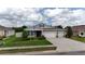 Beautiful single-Gathering home with well-maintained landscaping, three-car garage, and covered front porch at 449 Halter Dr, Apopka, FL 32712