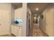 Inviting hallway entrance featuring hardwood floors, neutral paint, and attractive wainscoting at 449 Halter Dr, Apopka, FL 32712