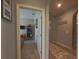 Hallway leading to a carpeted room, decorated with a wall hanging, and lit with recessed lighting at 449 Halter Dr, Apopka, FL 32712