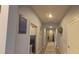 Hallway with light gray walls, arched entryway, and laminate floors at 449 Halter Dr, Apopka, FL 32712