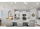 Bright kitchen with granite countertops, stainless appliances, barstool seating, and open to other rooms at 449 Halter Dr, Apopka, FL 32712