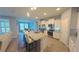 Open kitchen design with an island, breakfast bar, granite counters and stainless steel appliances at 449 Halter Dr, Apopka, FL 32712