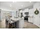 Open kitchen with granite countertops, stainless appliances, kitchen island, and barstool seating at 449 Halter Dr, Apopka, FL 32712