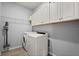 Laundry room featuring a washer, dryer, and overhead storage at 449 Halter Dr, Apopka, FL 32712