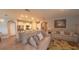 Open living space with a kitchen featuring white cabinetry and a large comfortable seating area at 449 Halter Dr, Apopka, FL 32712