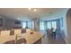 Open living area showcasing kitchen, living and dining areas, and sliding doors to outdoor space at 449 Halter Dr, Apopka, FL 32712