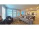 Cozy living room featuring plantation shutters, neutral paint, and access to the kitchen at 449 Halter Dr, Apopka, FL 32712