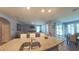 Living area with kitchen bar, view of dining area and sliding doors to outdoor living at 449 Halter Dr, Apopka, FL 32712