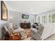 Cozy living room features plantation shutters, neutral paint, with comfortable seating and decorative accents at 449 Halter Dr, Apopka, FL 32712