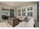 Covered patio with wicker seating and views to both the exterior and interior at 449 Halter Dr, Apopka, FL 32712