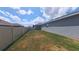 Spacious side yard features lush grass and a well-maintained privacy fence, perfect for outdoor activities at 449 Halter Dr, Apopka, FL 32712