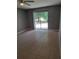 Bedroom with neutral walls, tiled flooring, ceiling fan and sliding door access to outdoor patio at 5005 Lindsay Ct, Orlando, FL 32821