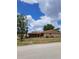 Charming single-story home with a well-maintained lawn and mature trees under a partly cloudy sky at 5005 Lindsay Ct, Orlando, FL 32821