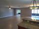 Open-concept living room featuring neutral walls, tile floors and sliding glass doors to screened patio at 5005 Lindsay Ct, Orlando, FL 32821