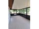 Enclosed back patio featuring tiled floors and views of the surrounding yard and landscaping at 5005 Lindsay Ct, Orlando, FL 32821