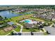 Aerial view of the community clubhouse, pool, playground, and lake at 5006 Caspian St, St Cloud, FL 34771