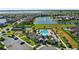 Aerial view of the community pool and clubhouse amenities with surrounding lake and residences at 5006 Caspian St, St Cloud, FL 34771