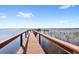View of dock and water with boats tied to it, blue skies and a few clouds above at 5006 Caspian St, St Cloud, FL 34771