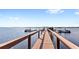 Waterfront property featuring a private wooden dock and boat mooring, perfect for enjoying lakeside living at 5006 Caspian St, St Cloud, FL 34771
