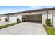 Attached one-car garage with concrete driveway and exterior door at 5006 Caspian St, St Cloud, FL 34771